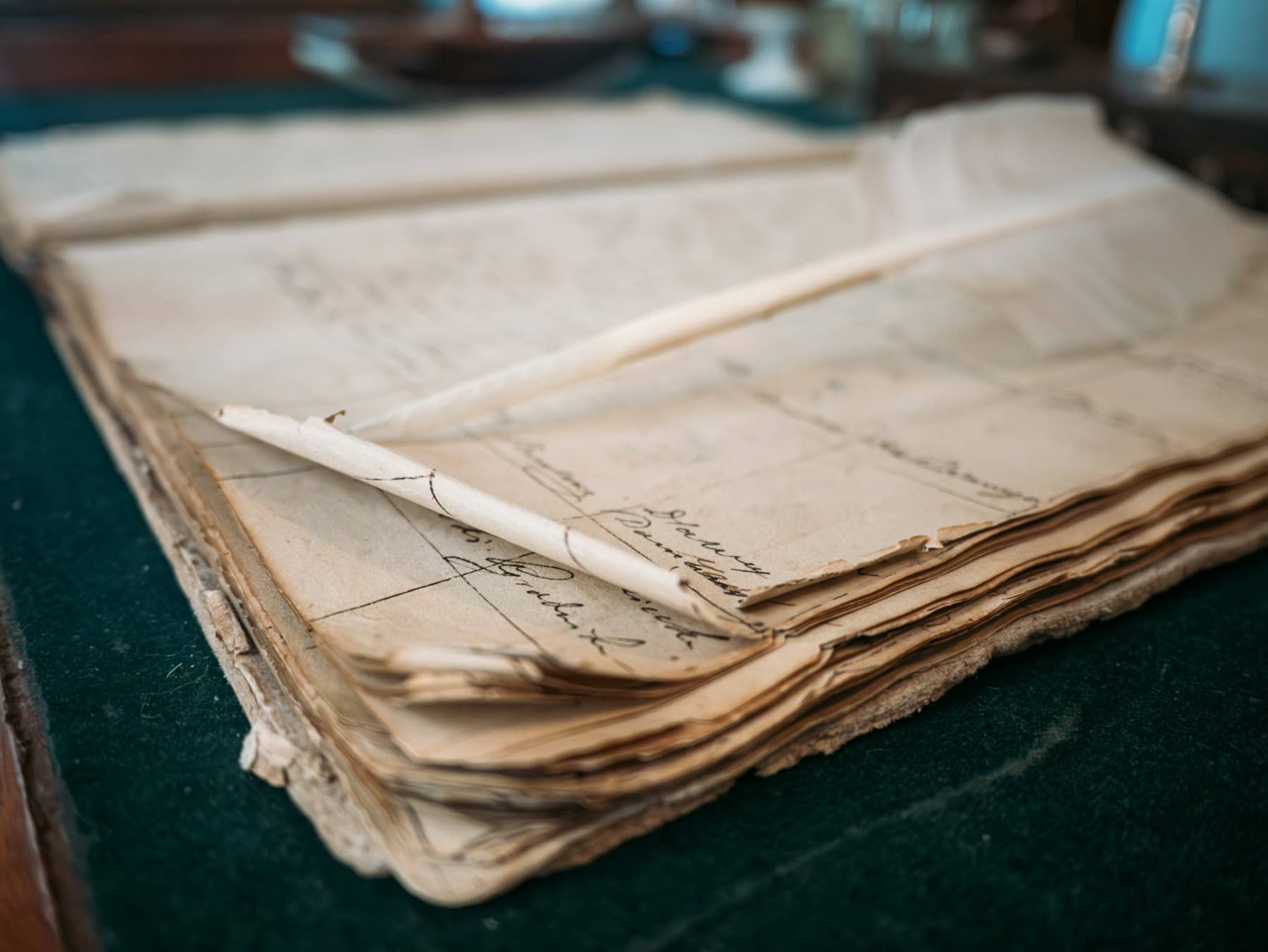 An old ledger lying open, handwritten entries in columns